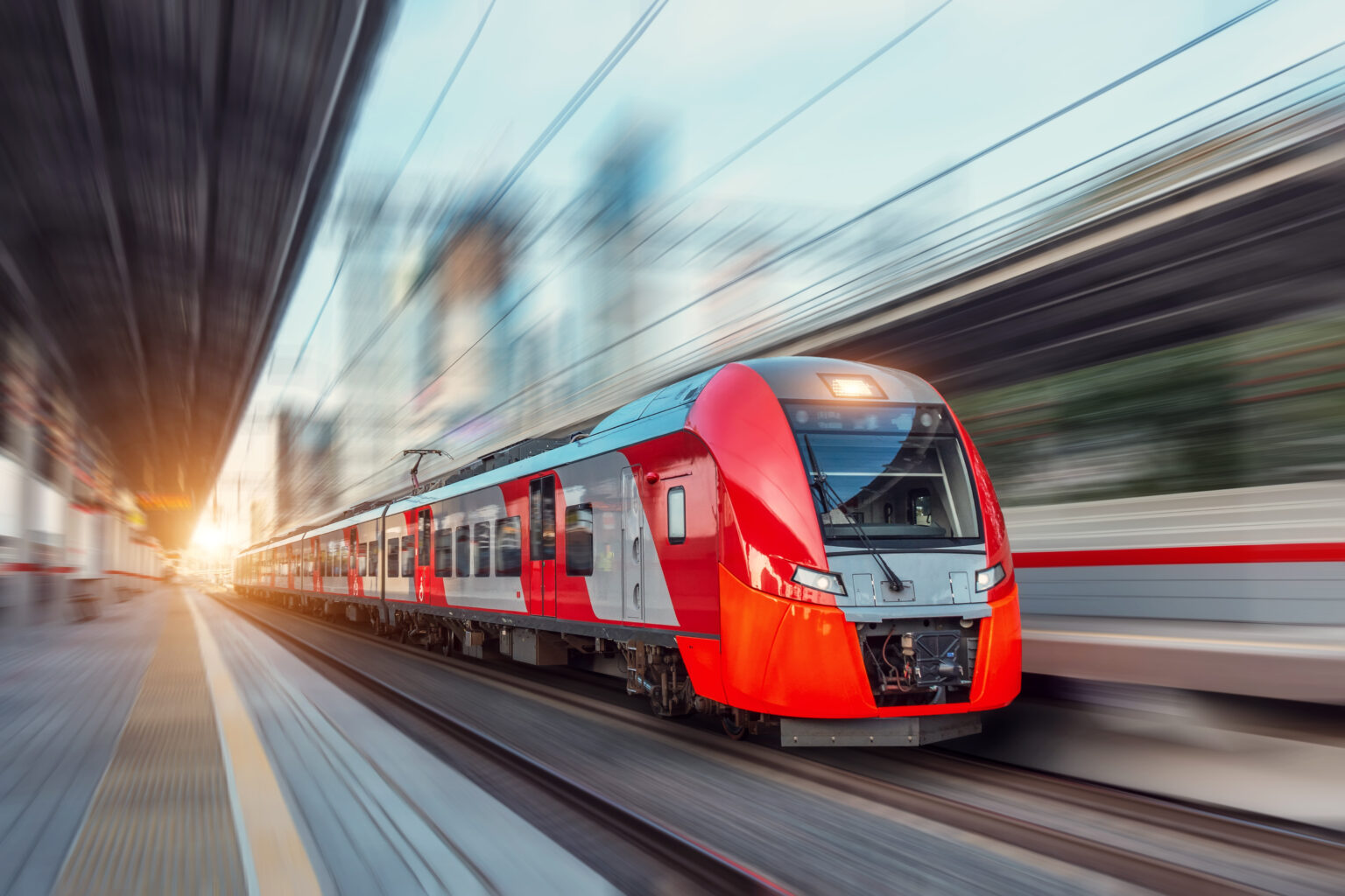 Motion-blurred picture of a red high-speed passenger train.