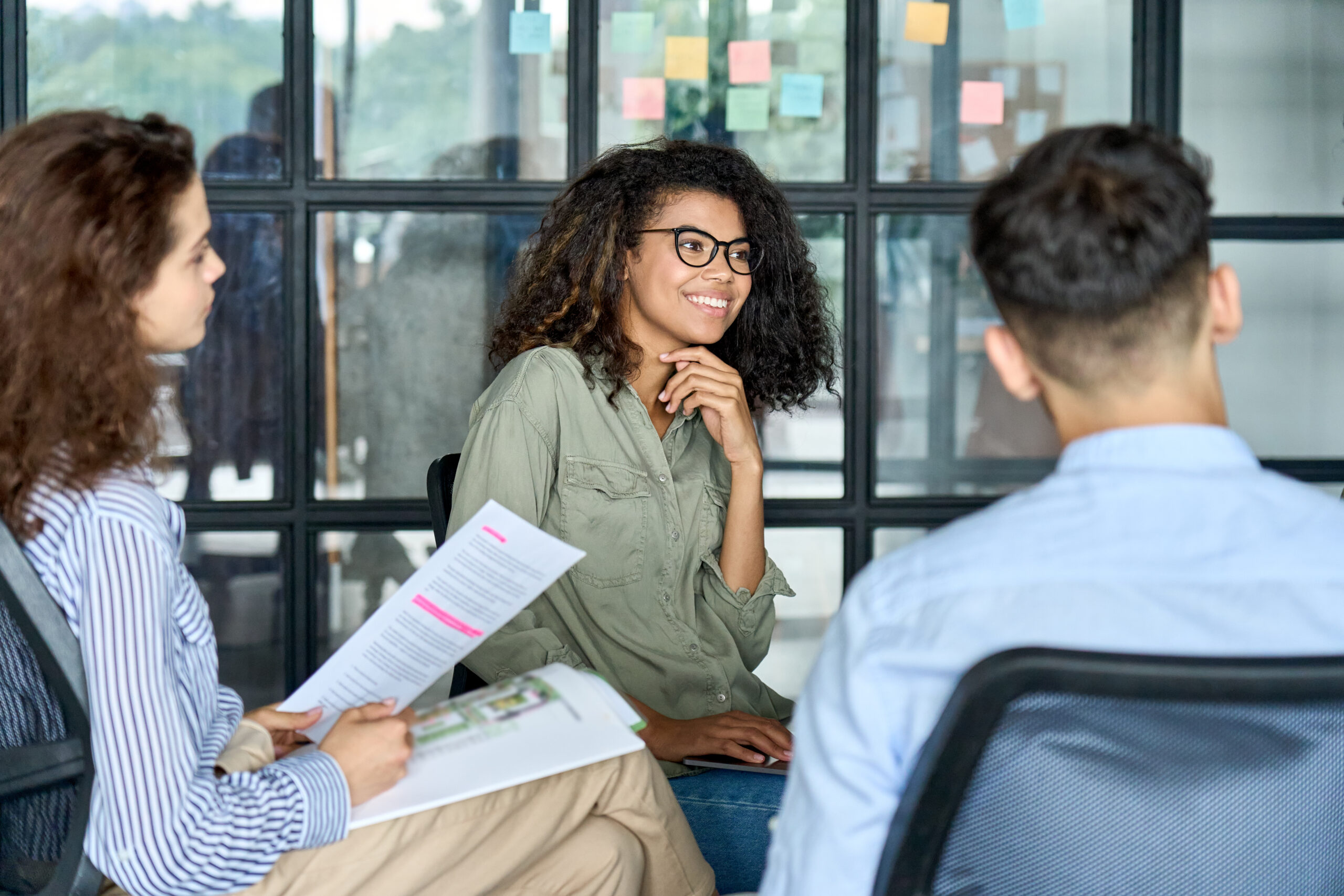 Smiling woman in a group discussion.