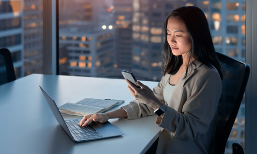 Woman working in office at night